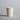 Biodegradable paper cup with green eco-friendly logos on a gray background