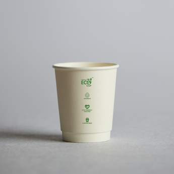 Biodegradable paper cup with green eco-friendly logos on a gray background