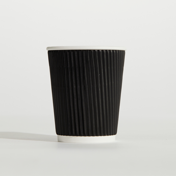 Black paper cup with a white rim on a light gray background