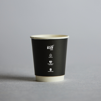 Black paper cup with eco-friendly logos on a gray background