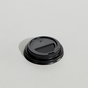 Black coffee cup lid on a light gray background
