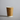 Brown paper cup with a white rim on a gray background